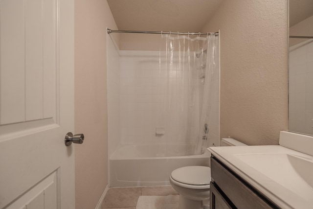 bathroom featuring vanity, tile patterned flooring, toilet, a textured wall, and shower / tub combo with curtain