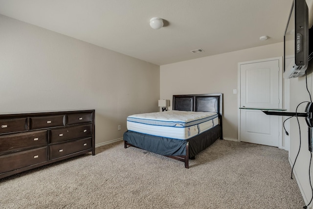 bedroom featuring light colored carpet, visible vents, and baseboards