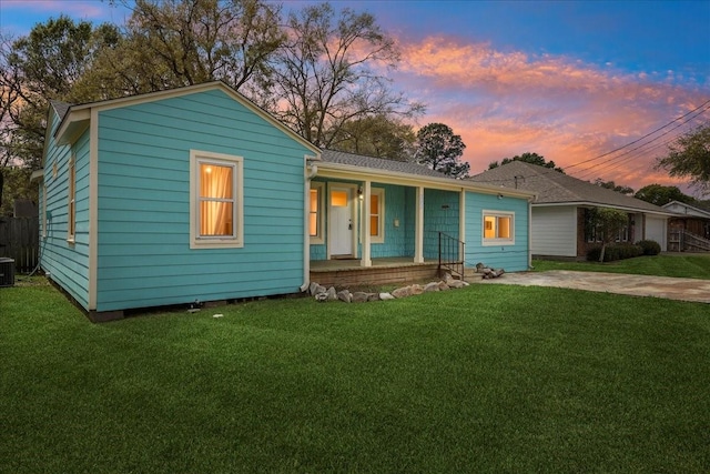 203 N 21st St, Nederland, TX 77627 - view of front of house with a porch, a lawn, and cooling unit