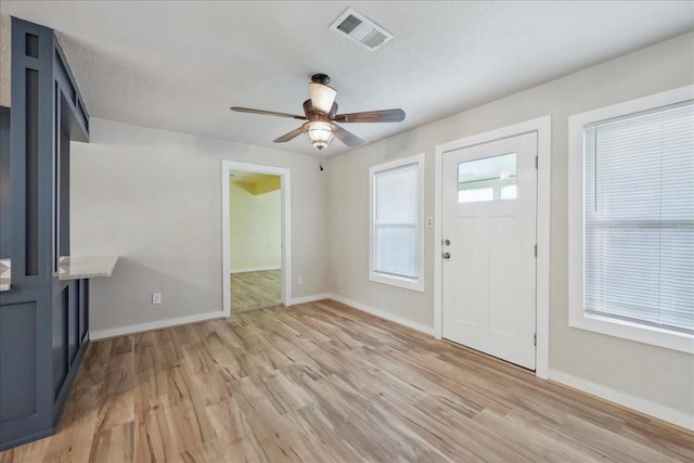 203 N 21st St, Nederland, TX 77627 - foyer with light wood-style flooring, baseboards, and ceiling fan