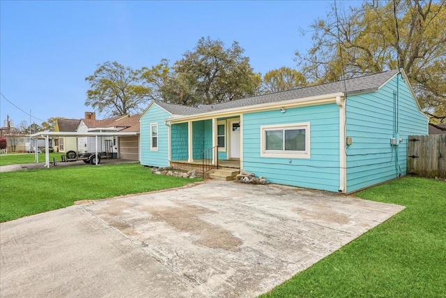 203 N 21st St, Nederland, TX 77627 - view of front of property featuring covered porch, roof with shingles, and a carport