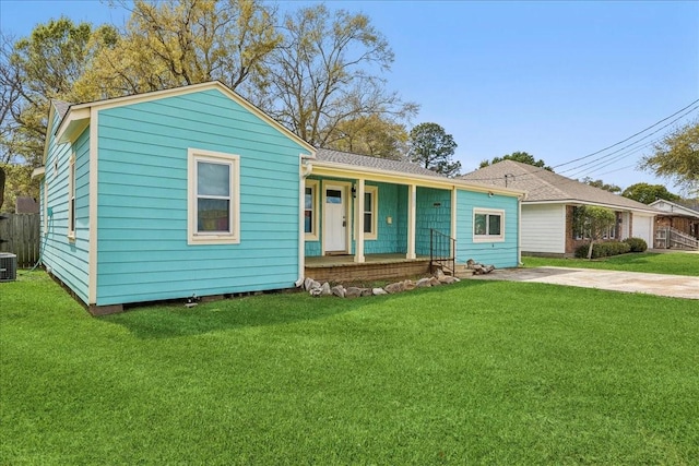203 N 21st St, Nederland, TX 77627 - view of front of property with covered porch, a front yard, and central AC unit