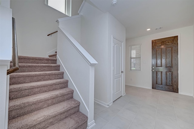 entryway with visible vents, stairs, baseboards, recessed lighting, and light tile patterned flooring