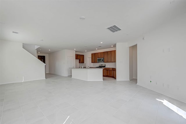 unfurnished living room with baseboards, recessed lighting, light tile patterned flooring, and visible vents