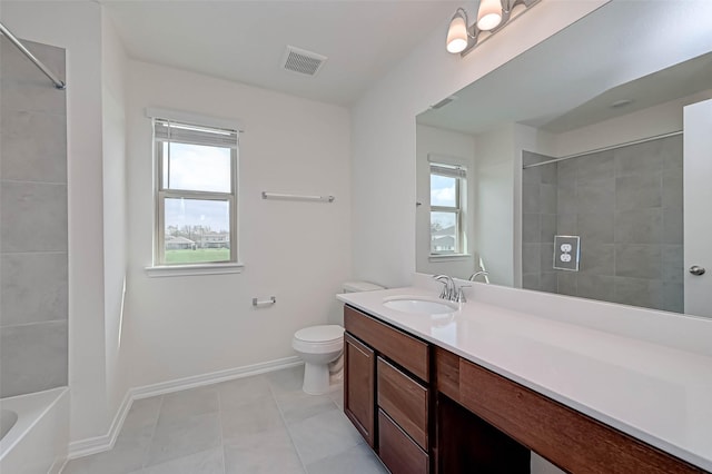 bathroom with vanity, toilet, tile patterned floors, baseboards, and visible vents