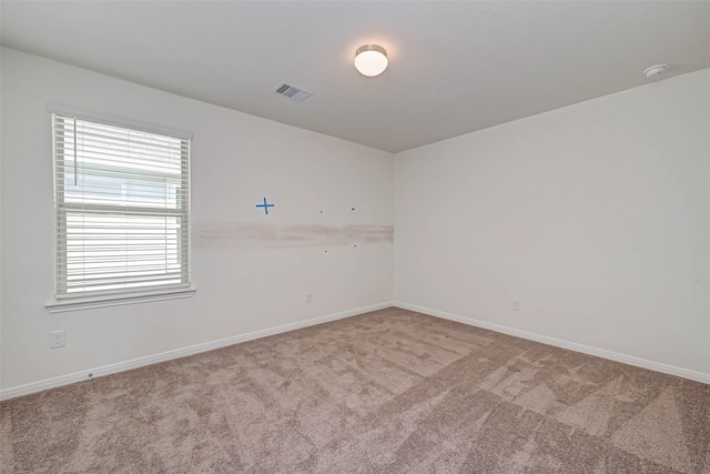 carpeted empty room with baseboards and visible vents