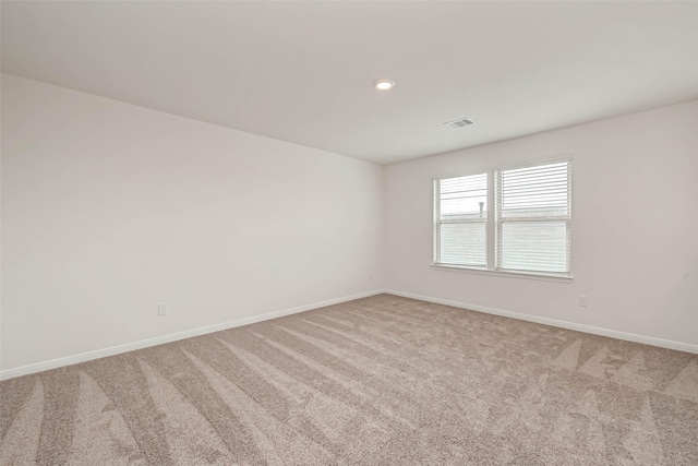 carpeted spare room featuring recessed lighting and baseboards