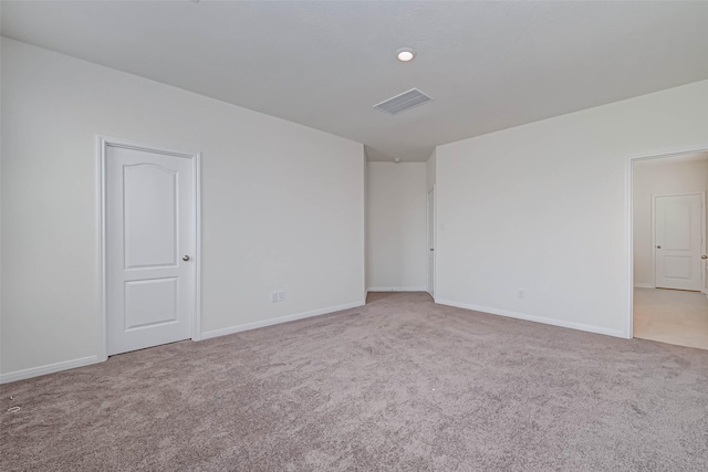 carpeted empty room featuring visible vents and baseboards