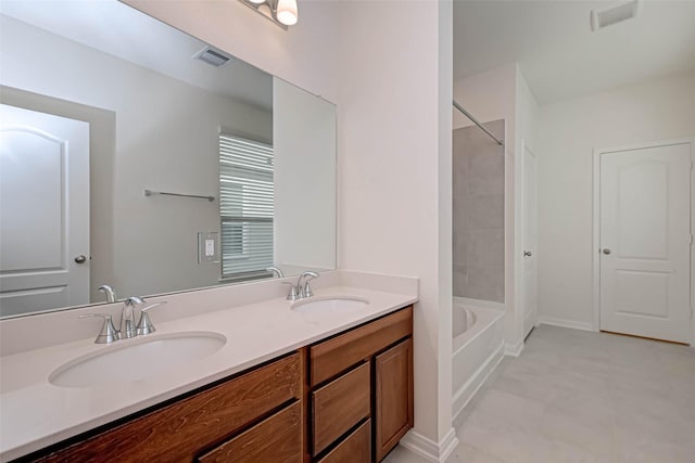 bathroom featuring visible vents, a sink, washtub / shower combination, and double vanity