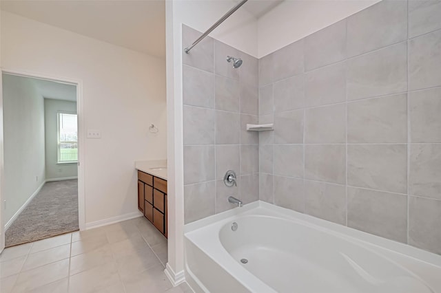full bathroom featuring washtub / shower combination, baseboards, vanity, and tile patterned floors