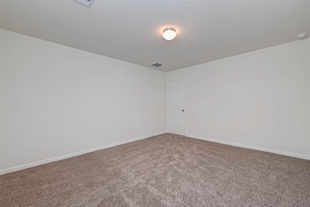 carpeted empty room with visible vents and baseboards