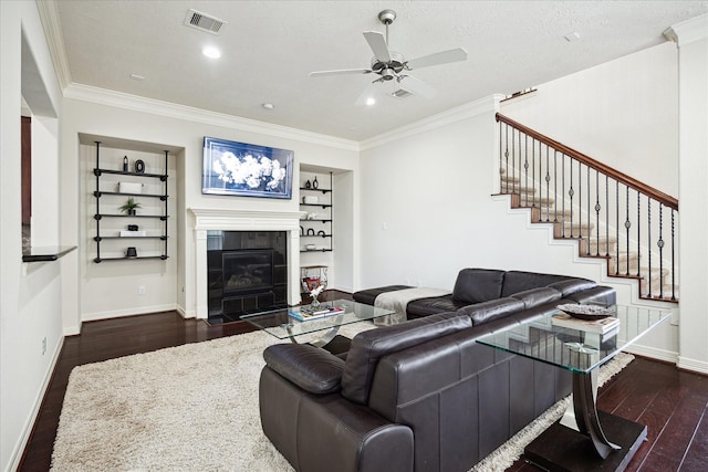 3031 Royal Oaks Grv, Houston, TX 77082 - living room with dark wood-style floors, ceiling fan, baseboards, a tiled fireplace, and crown molding