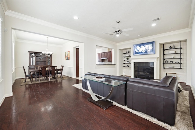 3031 Royal Oaks Grv, Houston, TX 77082 - living room featuring wood-type flooring, a ceiling fan, a tiled fireplace, a chandelier, and crown molding