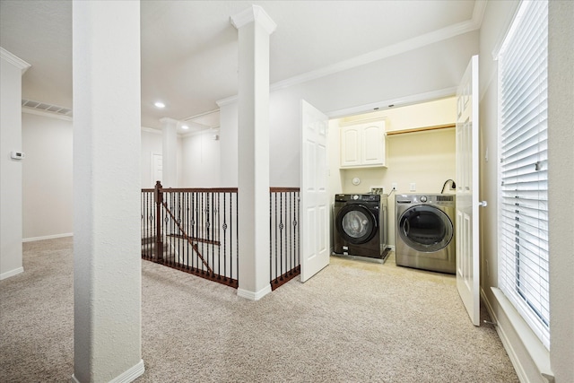 3031 Royal Oaks Grv, Houston, TX 77082 - laundry room featuring washer and clothes dryer, light carpet, ornamental molding, cabinet space, and plenty of natural light
