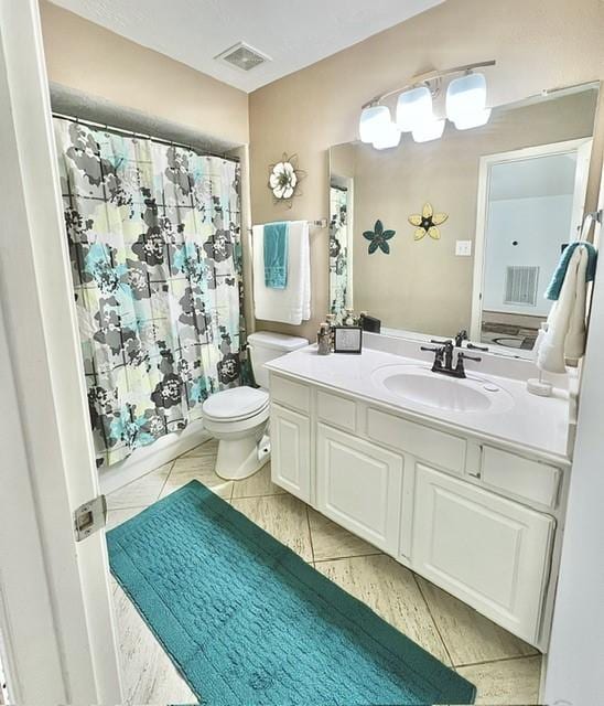 bathroom with toilet, visible vents, curtained shower, and vanity