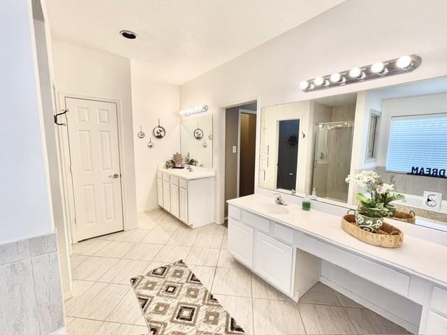 bathroom featuring vanity, tile patterned floors, a bath, and a stall shower