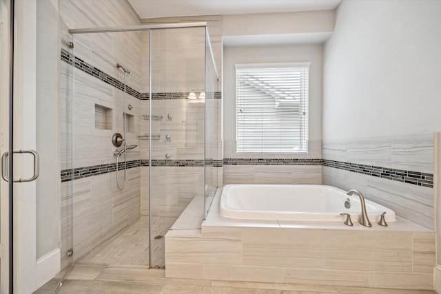 bathroom with a garden tub and a shower stall