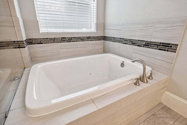 full bath featuring a jetted tub