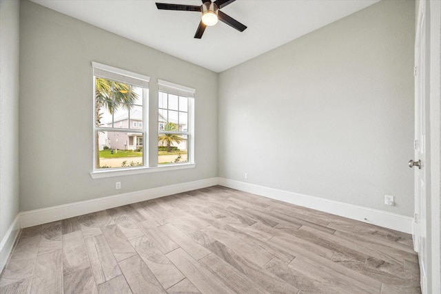 empty room featuring baseboards and ceiling fan