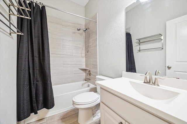 bathroom featuring vanity, wood finished floors, toilet, a textured wall, and shower / tub combo with curtain