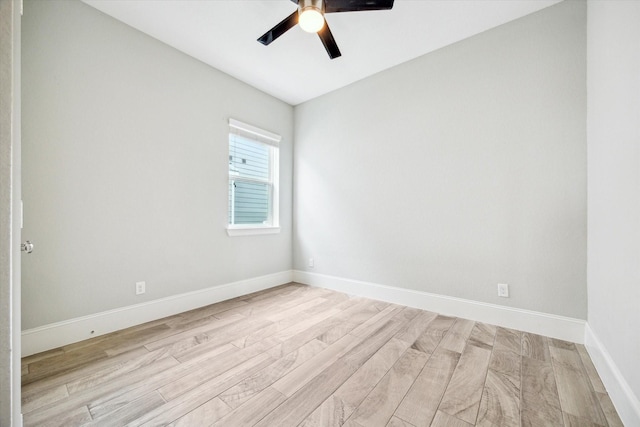spare room with light wood-style flooring, baseboards, and ceiling fan