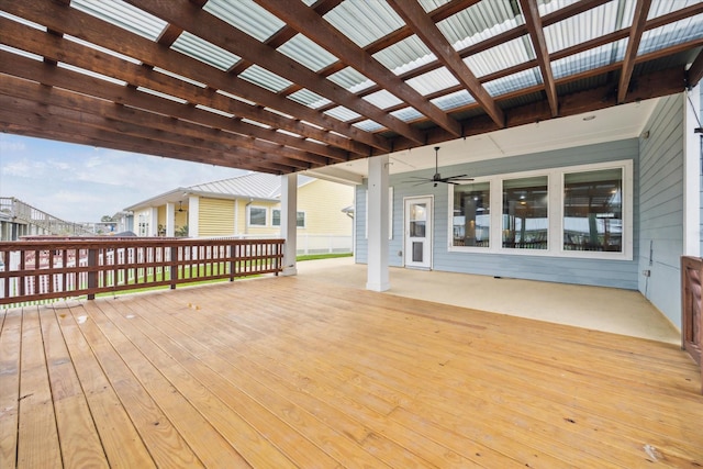 wooden terrace featuring a ceiling fan and a pergola