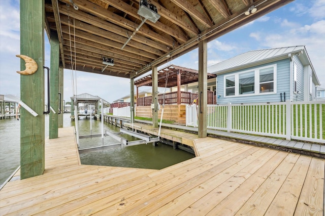 dock area with boat lift and a water view