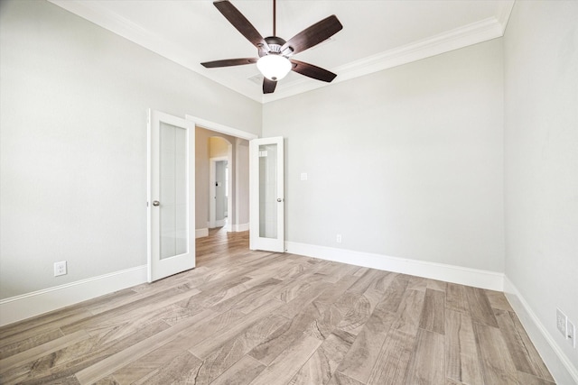empty room with light wood finished floors, french doors, ceiling fan, and ornamental molding