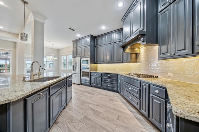 kitchen with tasteful backsplash, visible vents, appliances with stainless steel finishes, and a sink
