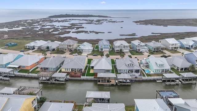 drone / aerial view with a residential view and a water view