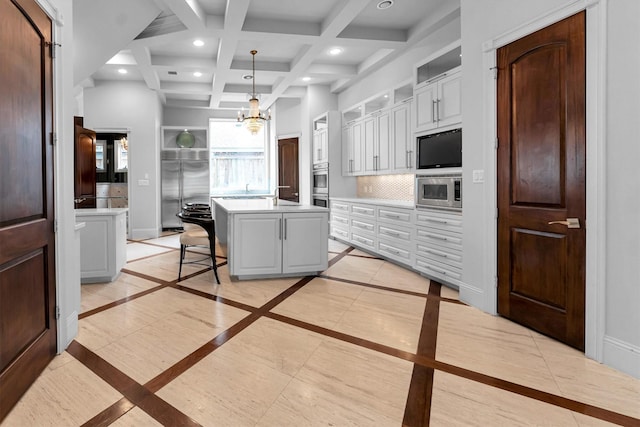 2247 Bartlett St, Houston, TX 77098 - kitchen featuring inlaid floor details, built in appliances, light countertops, recessed lighting, and beam ceiling