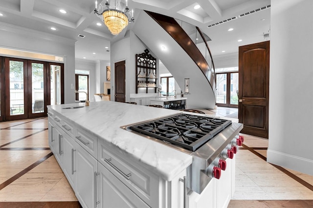 2247 Bartlett St, Houston, TX 77098 - kitchen featuring inlaid floor details, recessed lighting, coffered ceiling, stainless steel gas cooktop, and crown molding