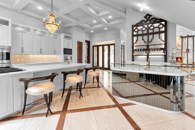 2247 Bartlett St, Houston, TX 77098 - kitchen with inlaid floor details, a towering ceiling, backsplash, beamed ceiling, and light countertops