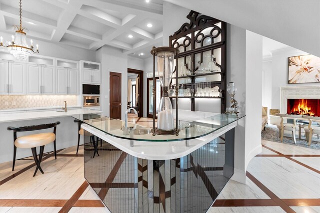 2247 Bartlett St, Houston, TX 77098 - dining room featuring inlaid floor details, recessed lighting, a high end fireplace, beam ceiling, and baseboards