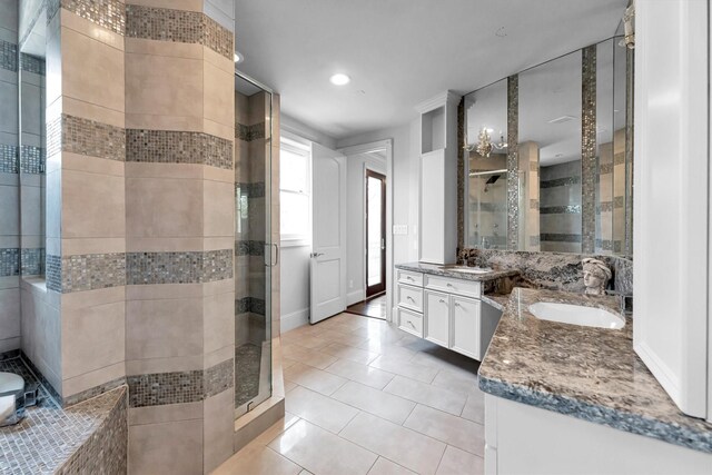 2247 Bartlett St, Houston, TX 77098 - bathroom with a shower stall, two vanities, tile patterned floors, and recessed lighting