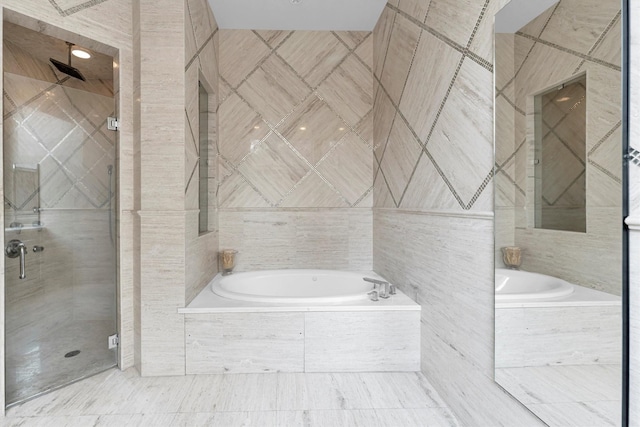 2247 Bartlett St, Houston, TX 77098 - full bath featuring a shower stall, a bath, and tile walls