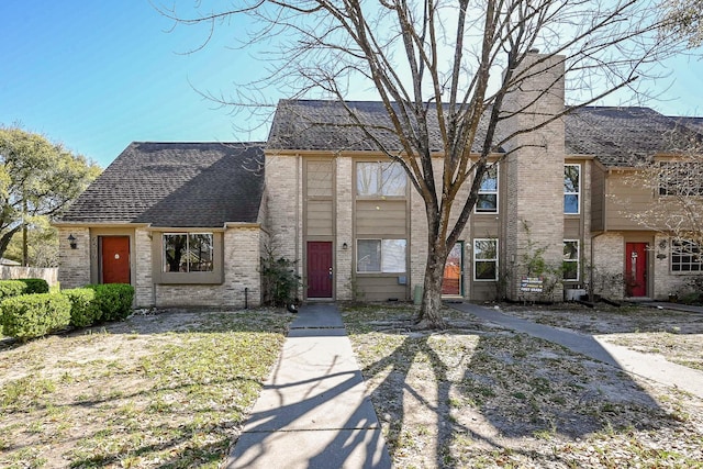 6514 Kentwick Dr, Houston, TX 77084 - view of front of house with a chimney, a shingled roof, and brick siding