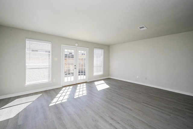 6514 Kentwick Dr, Houston, TX 77084 - unfurnished living room with french doors, baseboards, visible vents, and wood finished floors