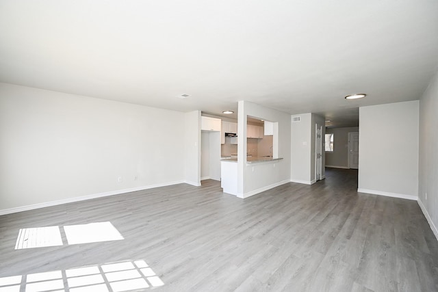 6514 Kentwick Dr, Houston, TX 77084 - unfurnished living room featuring baseboards and wood finished floors