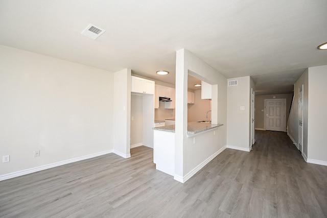 6514 Kentwick Dr, Houston, TX 77084 - unfurnished living room featuring visible vents, baseboards, and wood finished floors