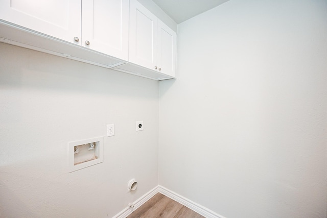 6514 Kentwick Dr, Houston, TX 77084 - laundry room with hookup for an electric dryer, baseboards, hookup for a washing machine, cabinet space, and light wood finished floors
