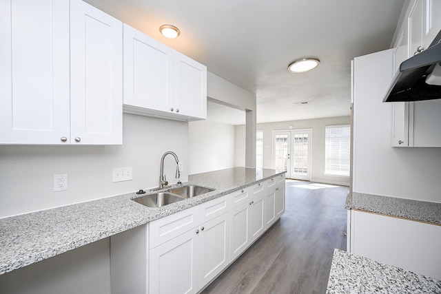 6514 Kentwick Dr, Houston, TX 77084 - kitchen with light stone counters, a sink, and white cabinets