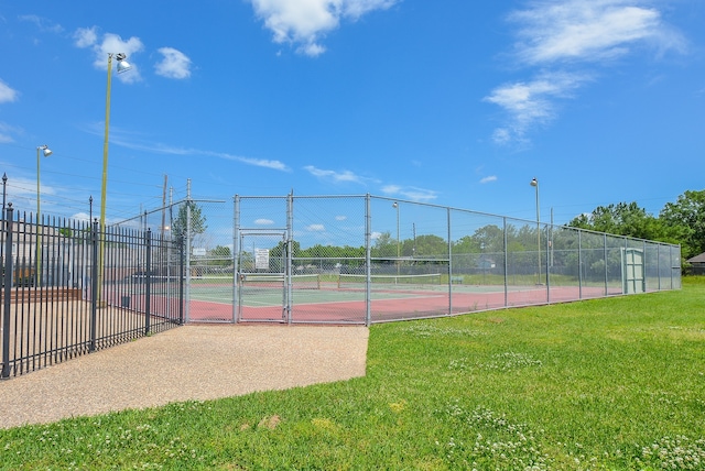 6514 Kentwick Dr, Houston, TX 77084 - view of sport court featuring fence, a gate, and a lawn
