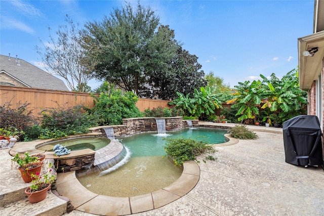 view of pool with a fenced in pool, a patio, an in ground hot tub, a grill, and a fenced backyard
