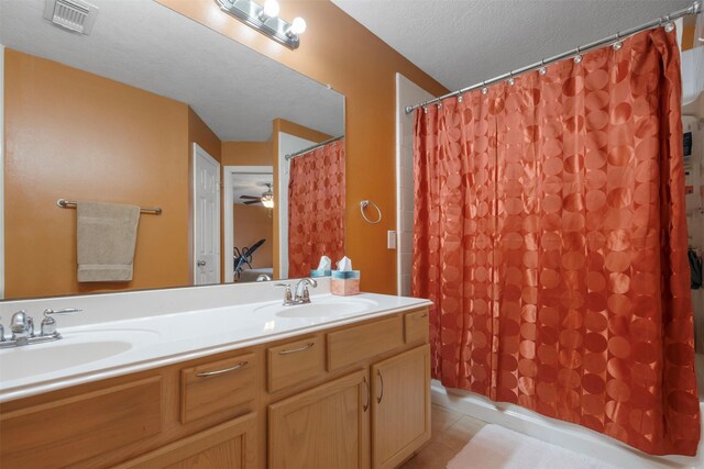 full bathroom with double vanity, visible vents, tile patterned floors, and a sink