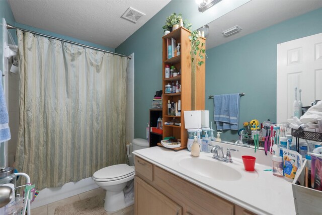 bathroom featuring vanity, tile patterned floors, toilet, and visible vents