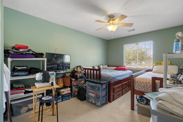 carpeted bedroom with visible vents and a ceiling fan