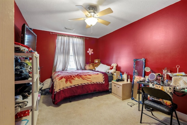 carpeted bedroom featuring visible vents and a ceiling fan