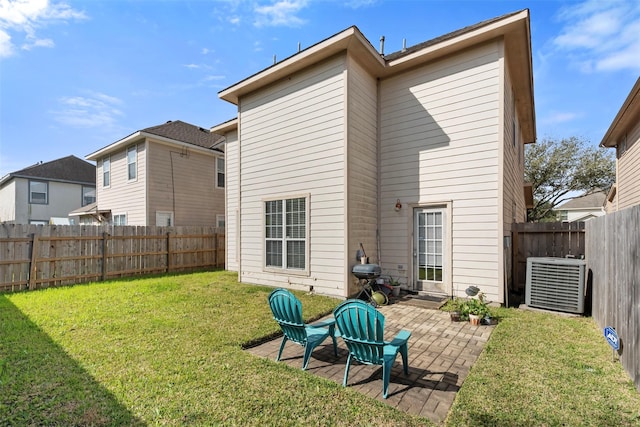 back of house with central air condition unit, a lawn, a fenced backyard, and a patio area