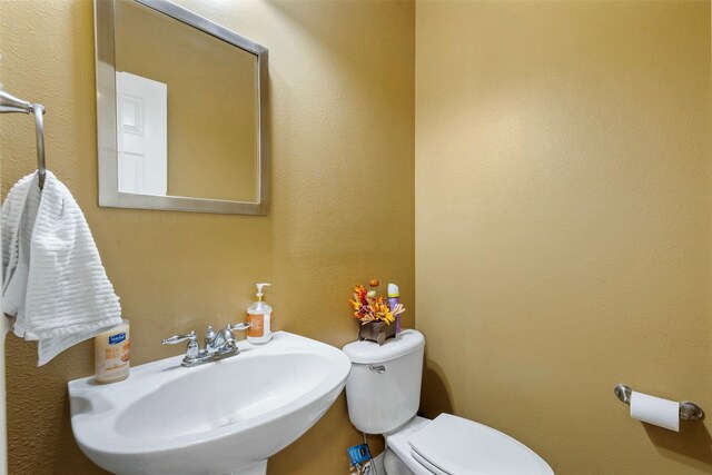 bathroom with toilet and a sink